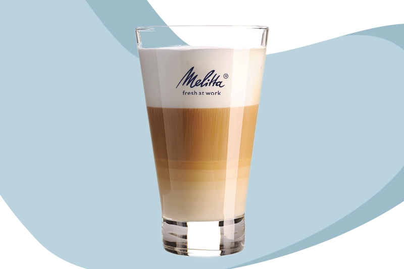 Geschichteter Latte Macchiato mit Milchschaum im Glas